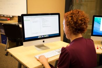 A person writing on a computer