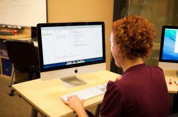 A person writing on a computer